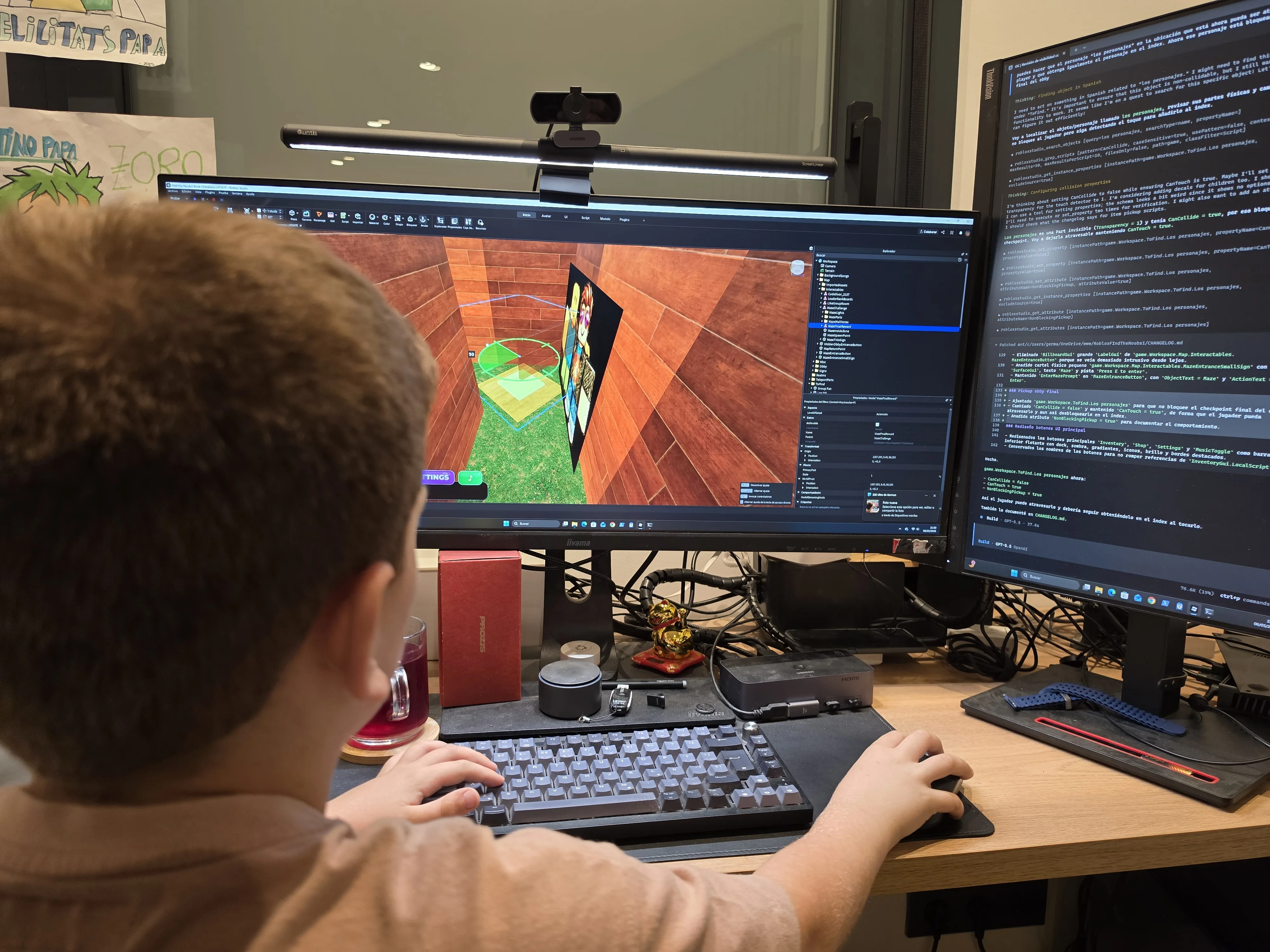Roc coding from behind at his computer, working on the Find the Noobsi Characters update in Roblox Studio
